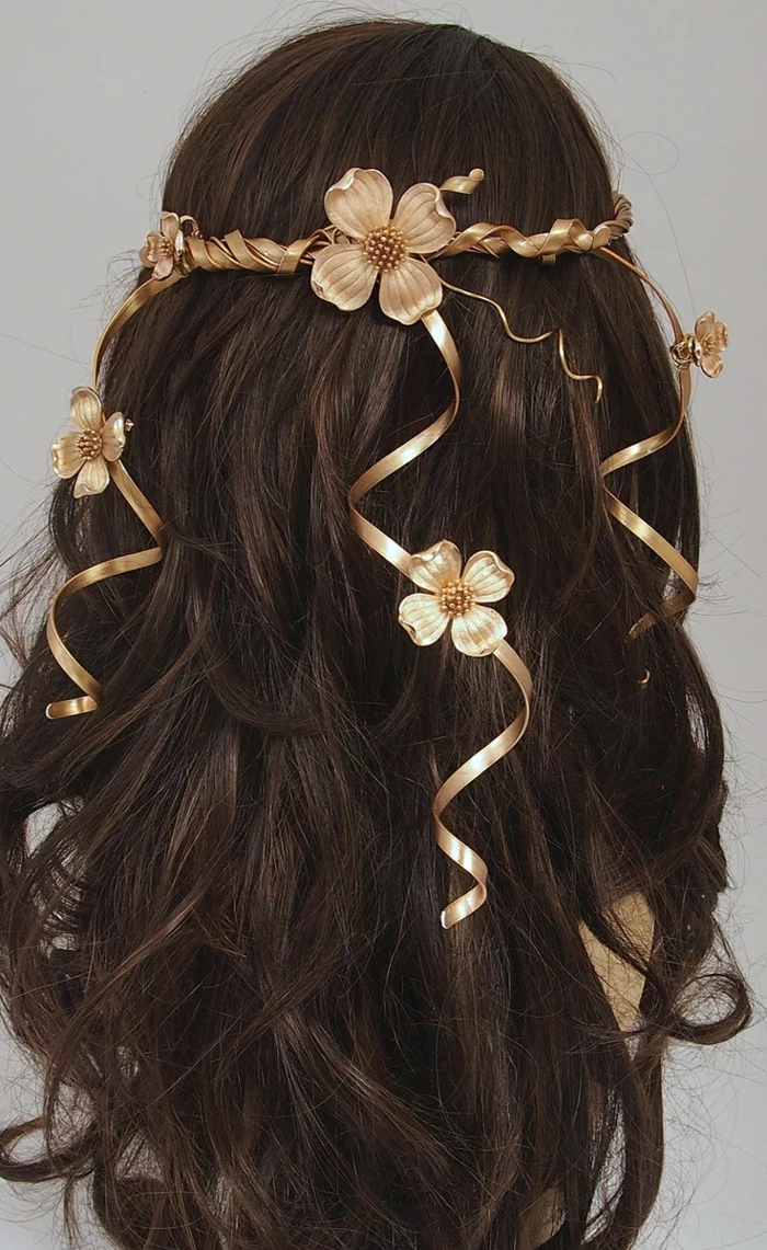 middle age hairstyles, dark brown long wavy hair, decorated with a golden diadem, featuring curly details, and several flowers