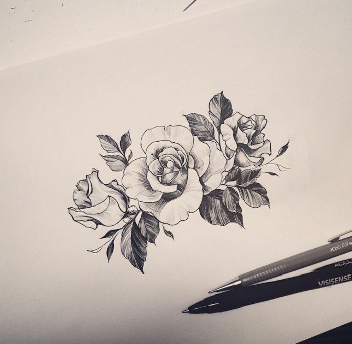 flower tattoo designs, black and white ink drawing of three roses with leaves, pencil and fineliner nearby