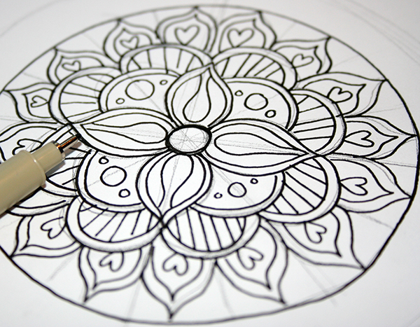 inked drawing of a flower mandala, black ink and pencil on white paper, craft ideas, fineliner nearby