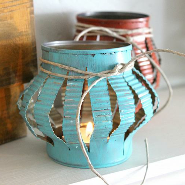 lanterns made from old tin cans, cut and pressed, diy craft projects, tied with thread, and containing small lit candles