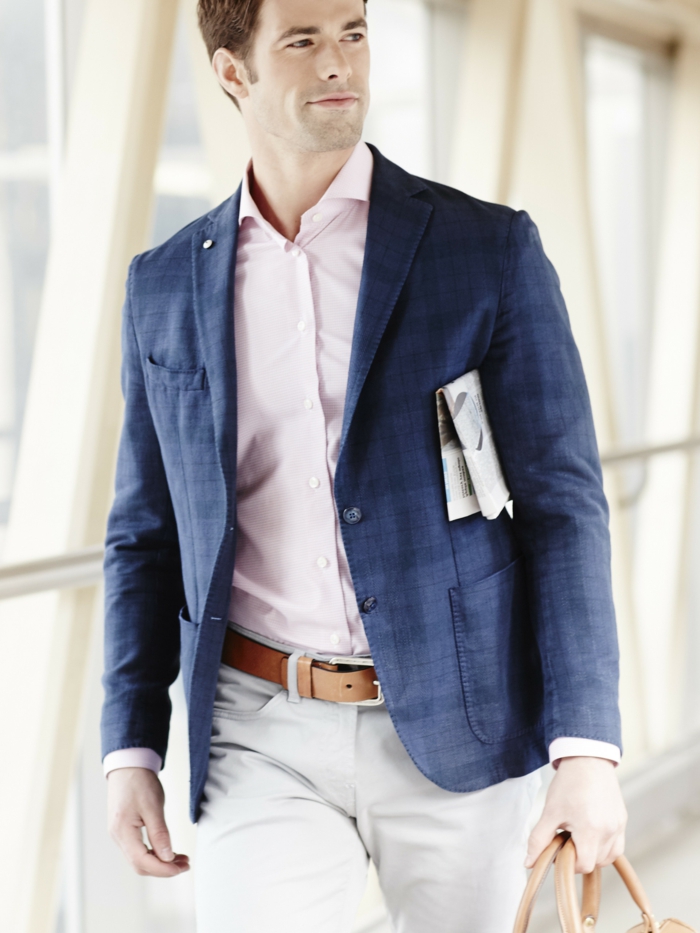 travelling businessman, wearing blue patterned blazer, pale pink shirt, and white pants with brown leather belt, business casual outfits