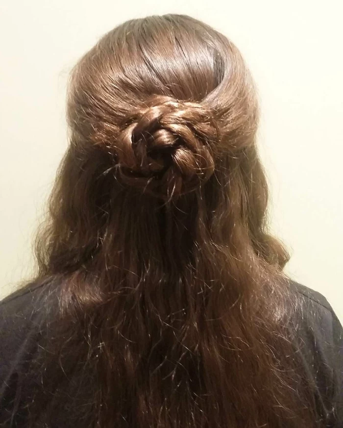 medieval braids, brown wavy hair, partially braided, to form a rose-like hair knot at the back