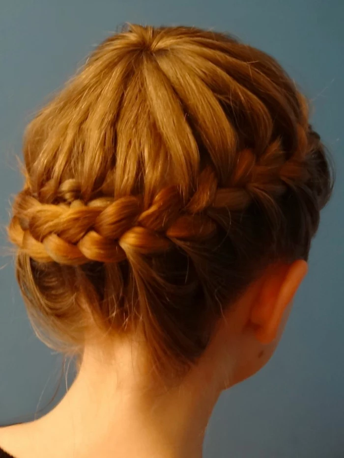 medieval hairstyles, close up of girl with ginger hair, woven into a side braid, going round her head