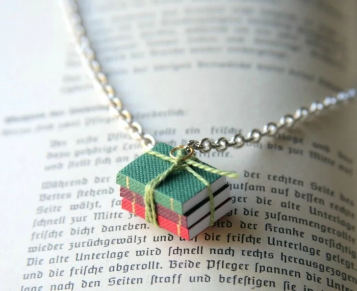 pendant made from three miniature books, tied together with green string, and attached to silver chain, easy arts and crafts, open book underneath