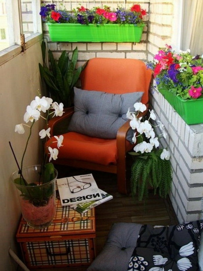 red chair with grey cushion, to bright green planters with colorful flowers, box in plaid serving as table, with potted orchid and magazines, porch ideas