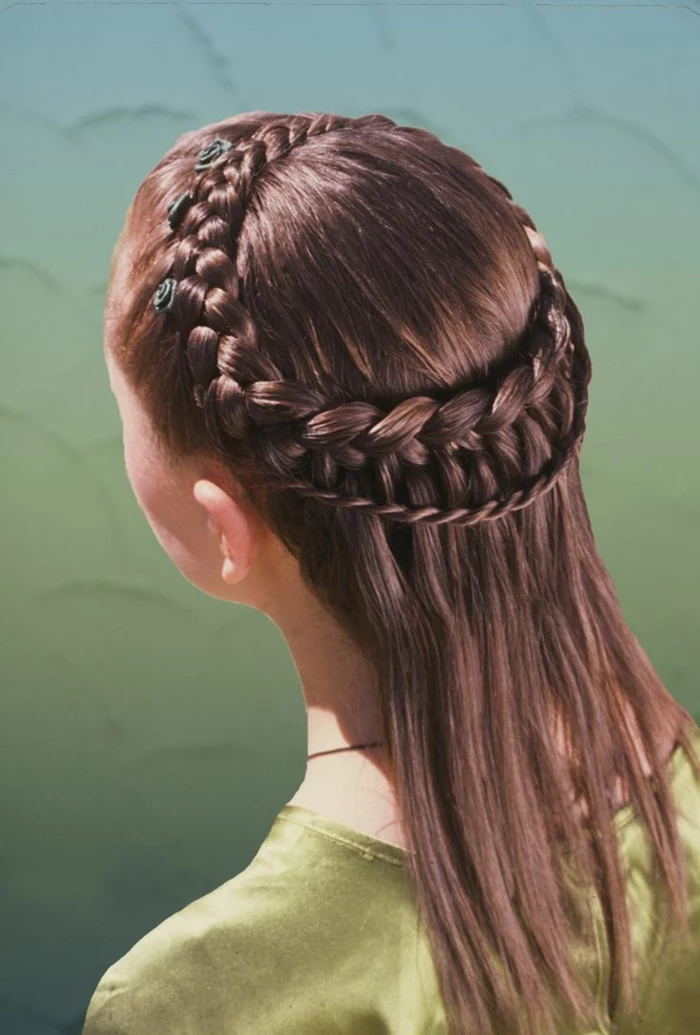 straight brunette hair, with two rows of differently sized braids at the top, going round the head like a crown, decorated with tiny black rose ornaments