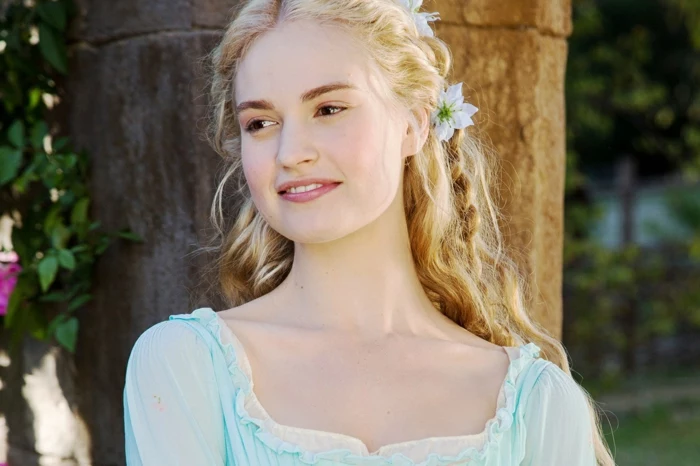 renaissance hairstyles, smiling blonde woman, in pale blue dress, with lace and frills, long wavy hair, with a braid and flowers