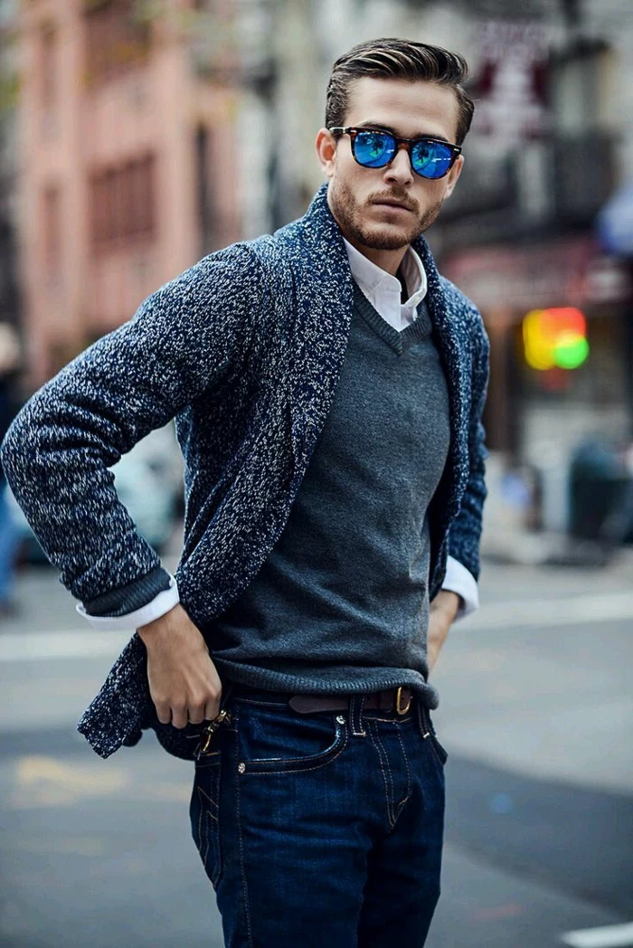 business casual jeans, worn by young man, in grey v-neck sweater, and white shirt, with pepper and salt grey cardigan, and sunglasses