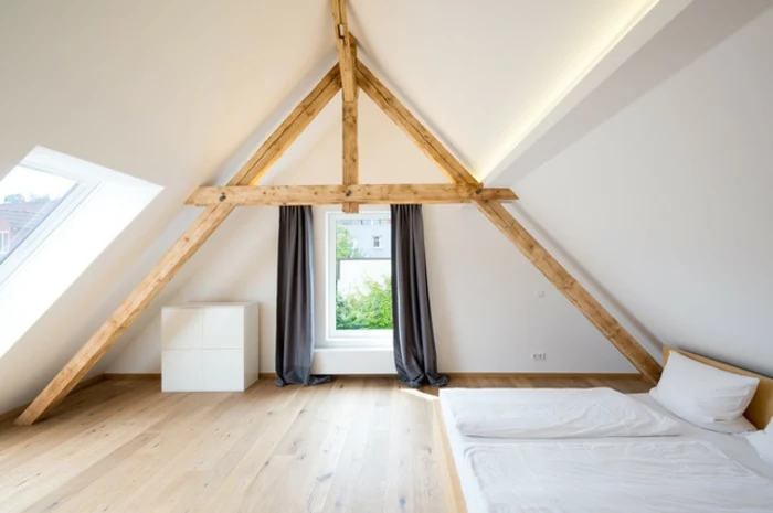 window treatment ideas, minimalist Scandinavian style attic, wooden beams and floor, dark grey curtains, two mattresses with pillows and covers