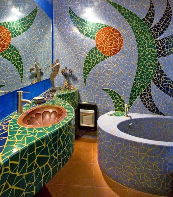 bathroom remodels, bathroom with multicolored mosaic, one blue wall with large mirror, inbuilt stone bathtub, brown tiled floor