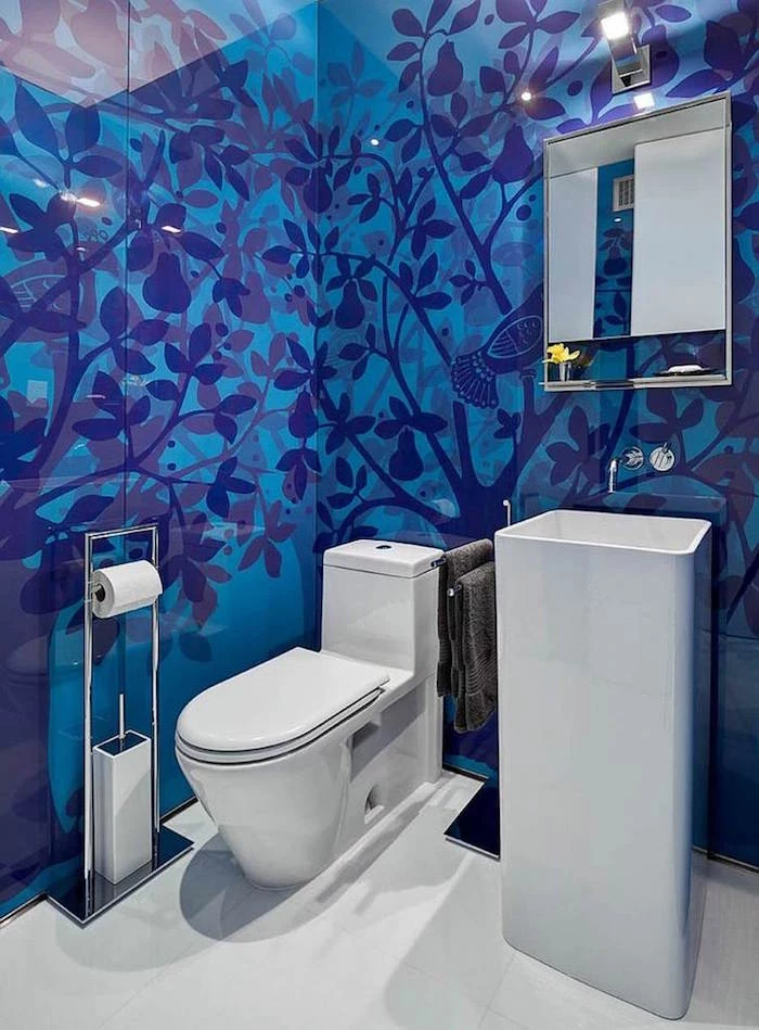 bathroom ideas, toilet with modern white toilet seat, unusual tall white sink, white floor and blue tiles, with dark blue pear trees and birds pattern