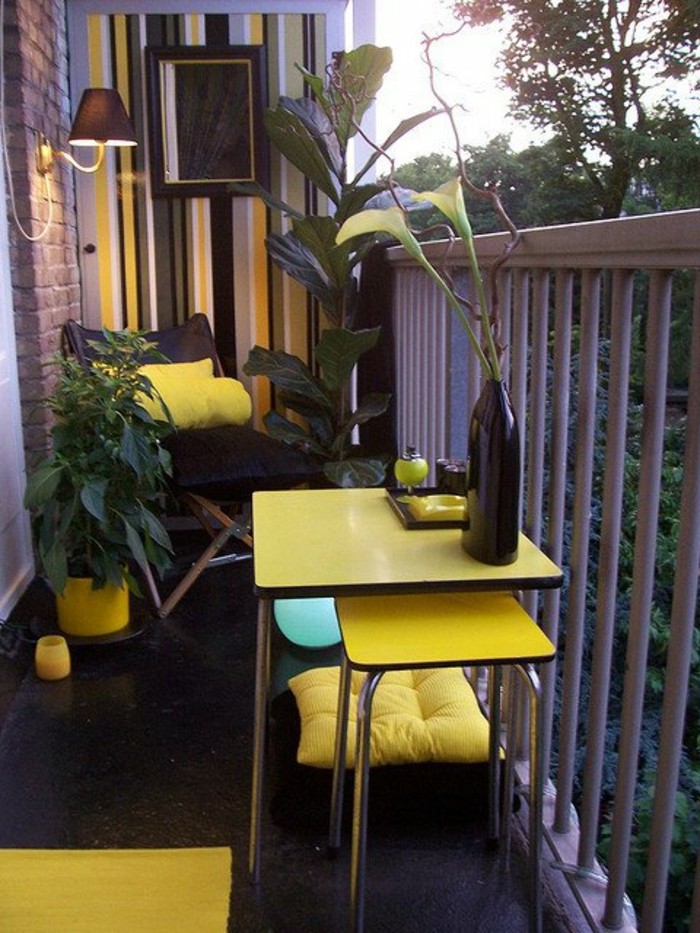 small-terrace-with-tiny-square-yellow-table-and-matching-chair-black-launge-chair-with-yellow-pillow-porch-ideas-yellow-rug-and-plant-pot-black-vase-various-plants tiny square yellow table, with matching chair underneath, black lounging chair with yellow cushion, porch ideas, grey white black and yellow wallpaper