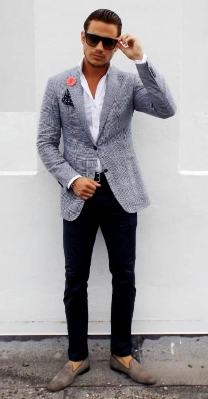 sunglasses-sporting man, with slicked back hair, wearing white shirt, black skinny pants, and a salt and chequered grey blazer, with handkerchiev and flower decoration, combined with business casual shoes,grey suede loafers