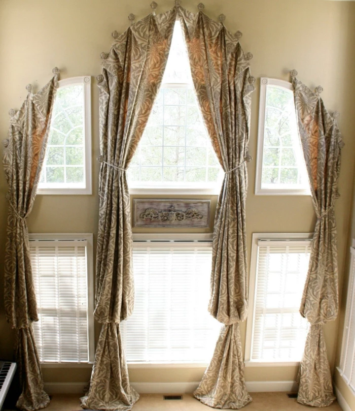 curtains for living room, two story windows, decorated with light brown and cream patterned curtains, bottom row windows have white blinds
