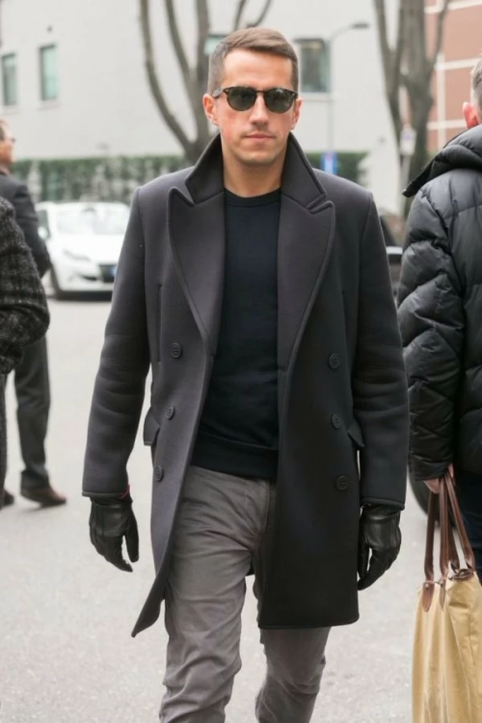 winter coat in black, over black jumper, business casual dress code, worn with black leather gloves, grey trousers and sunglasses