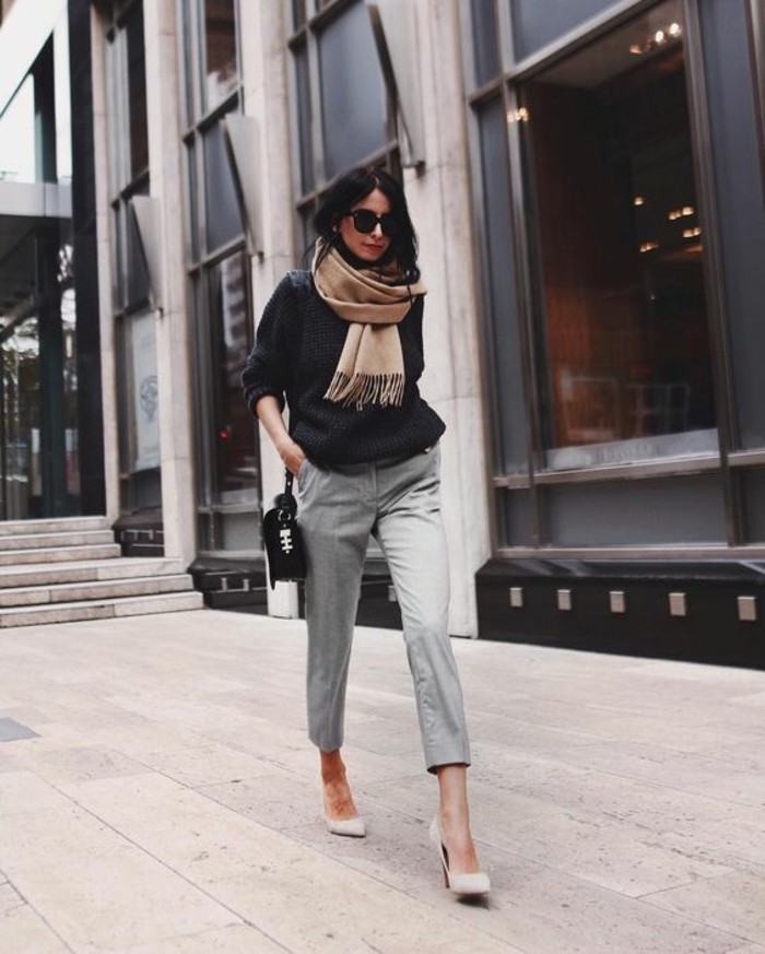 business casual women, brunette with sunglasses, wearing light grey woolen ankle trousers,and dark grey chunky knit sweater, with white heels and beige woolen scarf