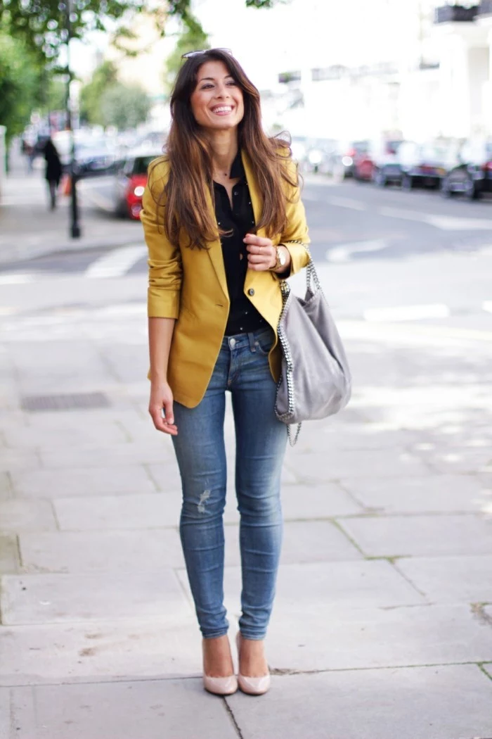 casual business attire, yellow blazer and black shirt, worn with distressed jeans, pale cream pumps and grey slouchy bag, by smiling brunette with long hair