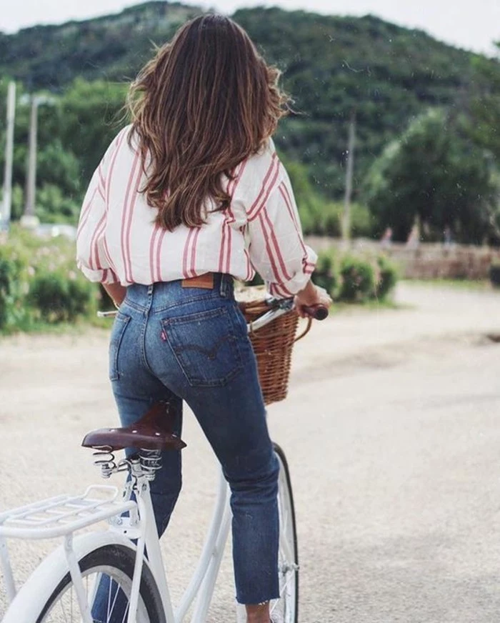 women outfits, oversized white shirt with red stripes, tucked into skinny jeans, worn by brunette woman on bike