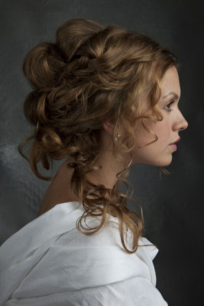medieval times hair, woman in profile, with brunette hair styled in an unusual hairdo, featuring loose curly strands, and twisted sections