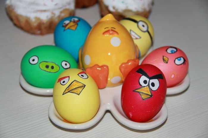 ceramic egg holder with chick figurine, with six easter eggs, made to look like five angry birds' characters, and a minion