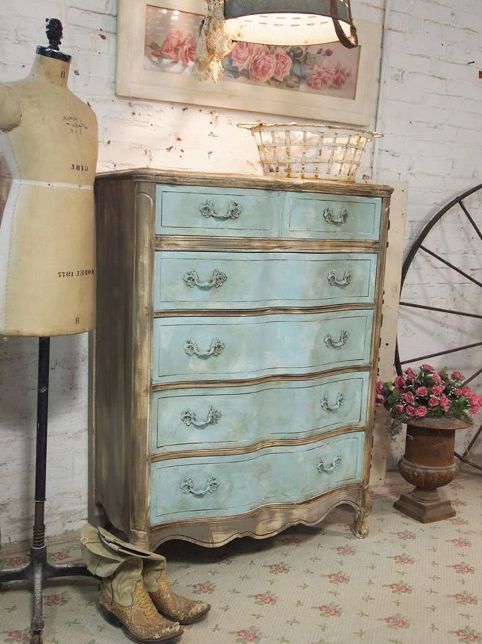 dresser in antique style, unevenly painted in grey-brown and pale turquoise, country cottage furniture, near vintage dressmaker's dummy and cowboy boots