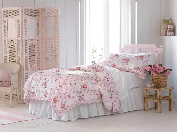 pastel pink screen and vintage armchair, in bedroom with white walls, bed with pink frame, white bedding and pink floral cover with matching pillow, shabby chic furniture 