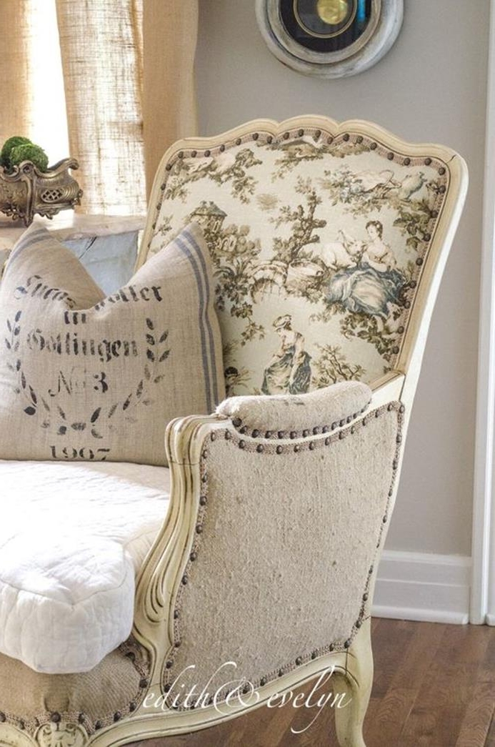 antique pattern on cream fabric, covering a vintage wing chair, with ivory and beige detailing, white and beige cushions