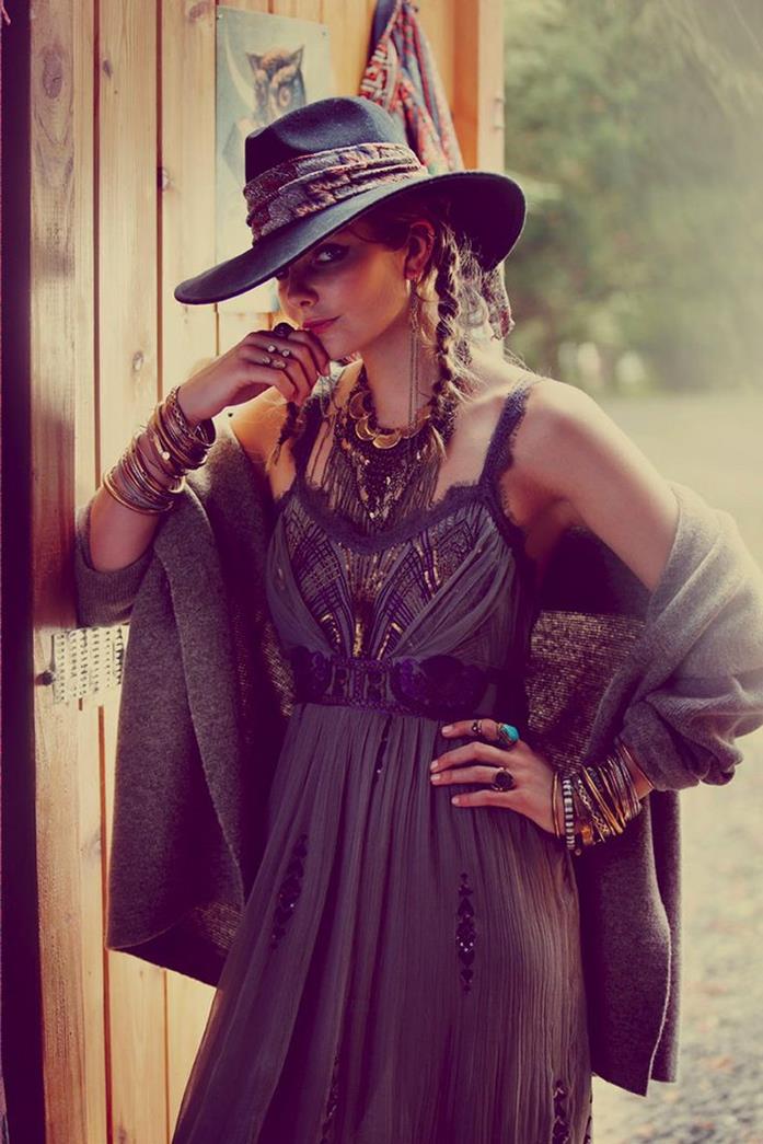 cowboy hat in black, on young, woman with two brunette braids, wearing black boho embroidered maxi dress, and a dark grey shawl, boho clothing