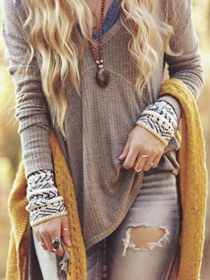 mink-colored jumper, over blue top, and white patterned jumper, layered boho chic look, worn with distressed torn pale grey jeans, and mustard yellow knitted shawl