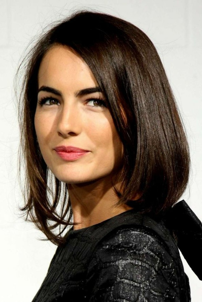 sparkly black patterned top, worn by smiling young woman, with smooth and straight, side-parted shoulder-length hair, brunette hairstyles