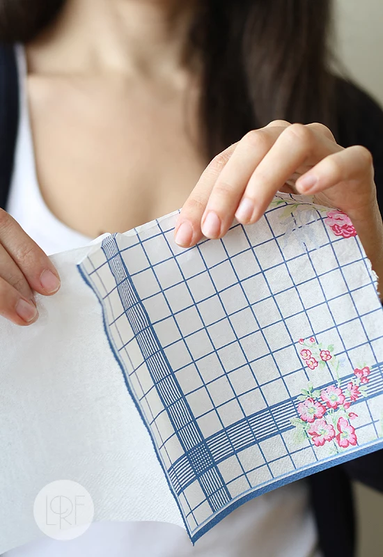 woman with dark brown hair, separating the top layer of a floral napkin, step by step coloring easter eggs