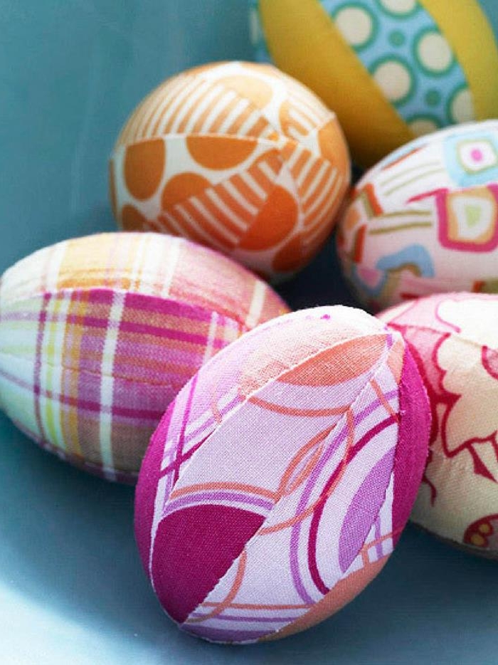 fabric pieces with patterns in different colors, sewn together, covering six eggs, easter egg designs 