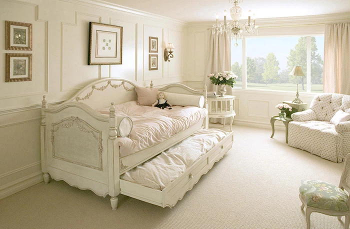 pale beige carpet, in a child's bedroom, white antique french sofa bed, with decorative elements, vintage armchair and small tables, shabby chic furniture, chandelier and old-looking chair