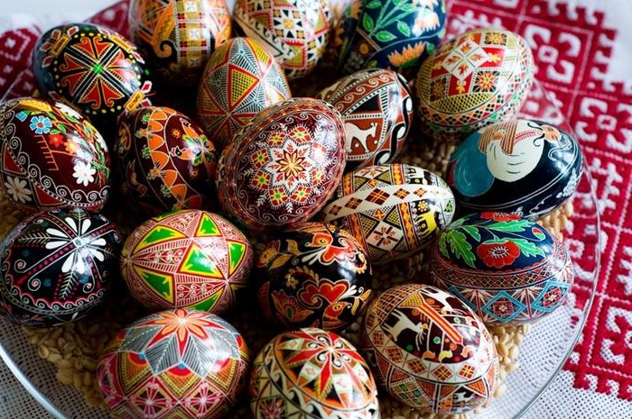 pile of professionally painted easter eggs, various colors and drawings, musician and flowers, animals and birds, european folklore style