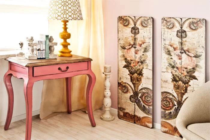 nightstand table in coral pink, in antique style with small drawer, country cottage furniture, decorative painted wooden boards, lamp and other items