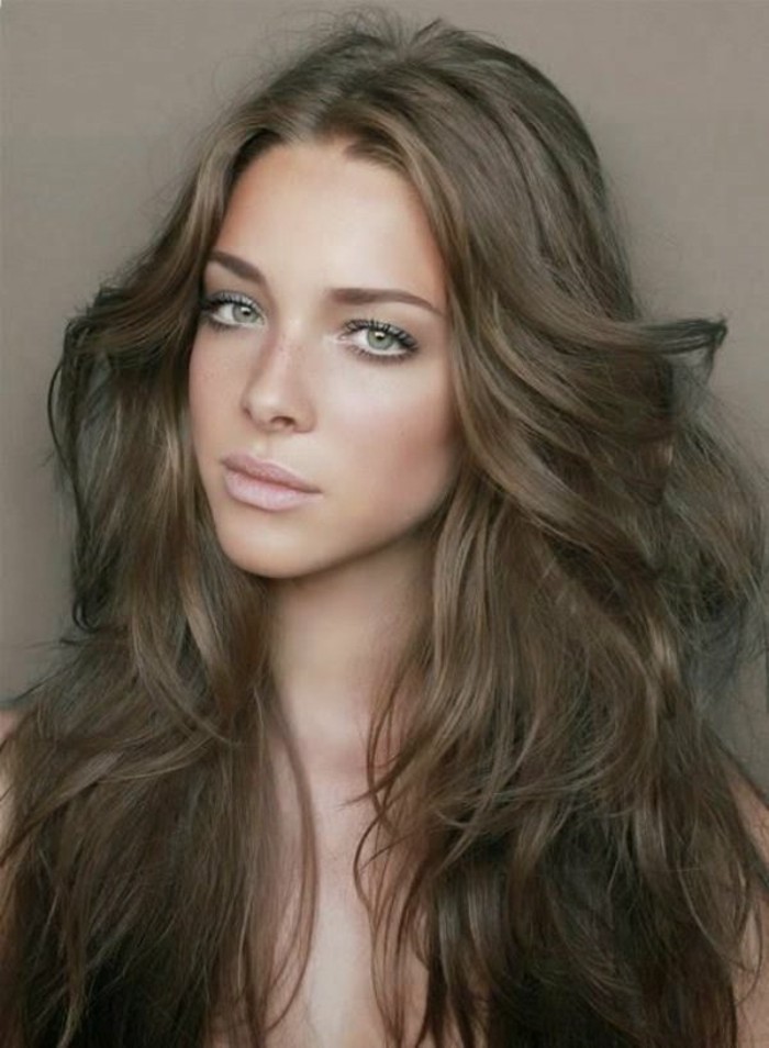 nude lipstick, discreet eye make up and blush, worn by woman with wavy, light brown hair, styled with 70s sweeps