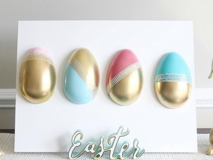 white board with four easter eggs, painted in gold, and different shades of blue and pink, easter egg decorating 