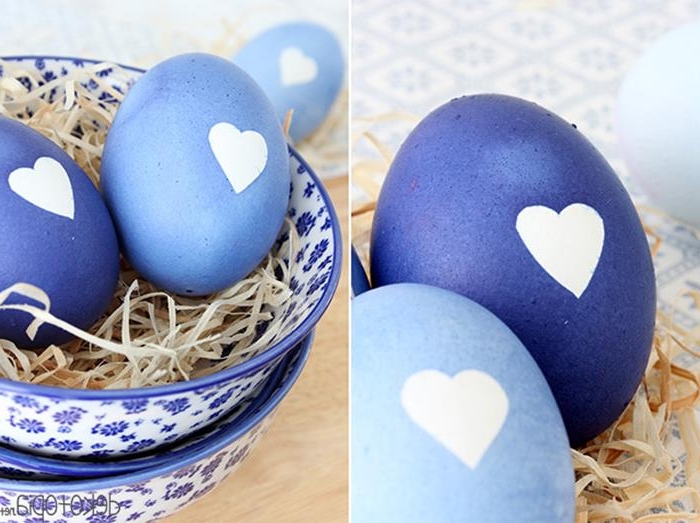 heart shapes in white, on eggs painted in different shades of blue, how to dye easter eggs, faux straw and patterned ceramic bowls