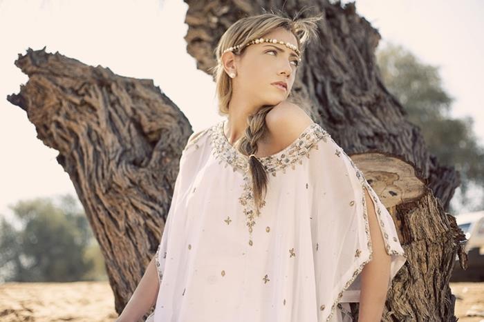 braided blond hair, on woman with beaded headband, bohemian style clothing, wearing floaty white off-shoulder blouse, with embroidery and beads