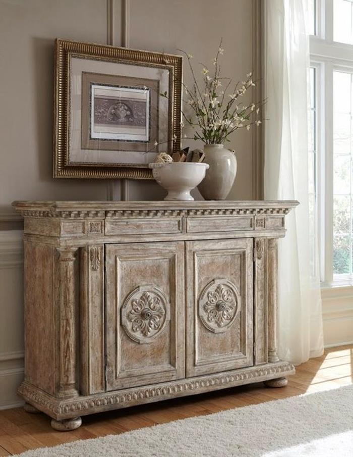 distressed and worn beige paint effect, on large antique wooden cupboard, framed painting and vases 