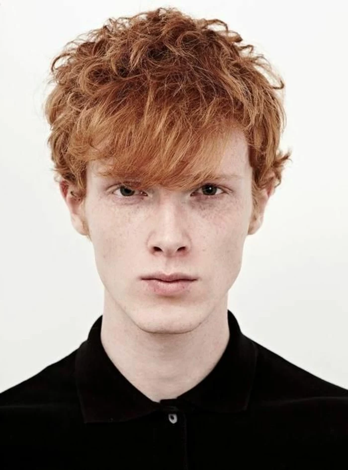 curled ginger hair, with long wavy bangs, partially falling over one eye, worn by brown-eyed teen, in black shirt