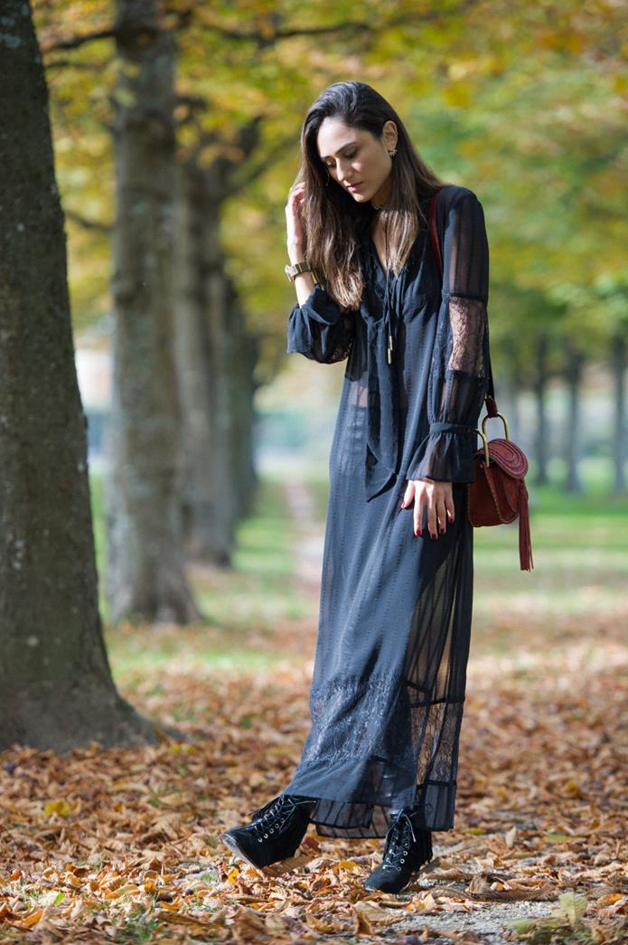 goth inspired maxi skirt, in boho style, made from semi-sheer black fabric, with matching top, worn by brunette woman