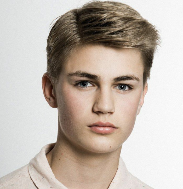 boy with light brown hair, featuring a side part and longer bangs, swept to one side, ideas for boys short haircuts
