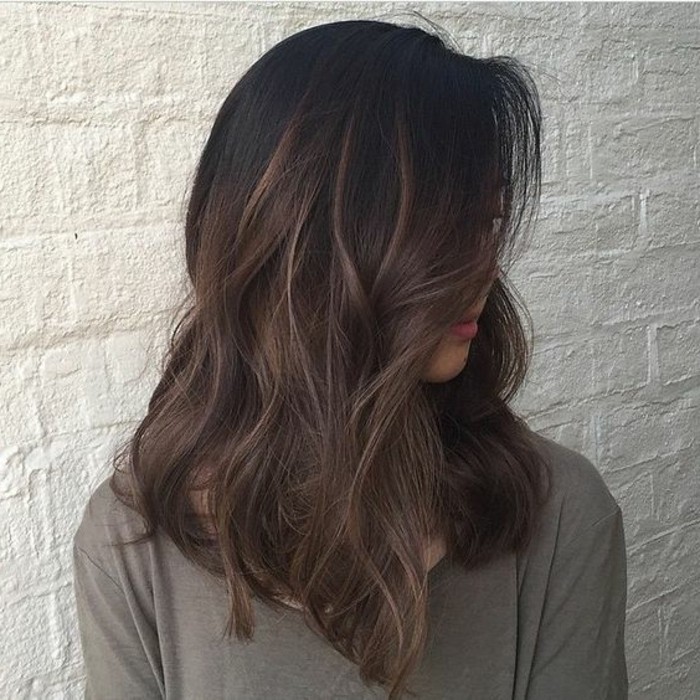 khaki top with long sleeves, worn by woman with wavy hair, and discreet highlights, brunette hair colors