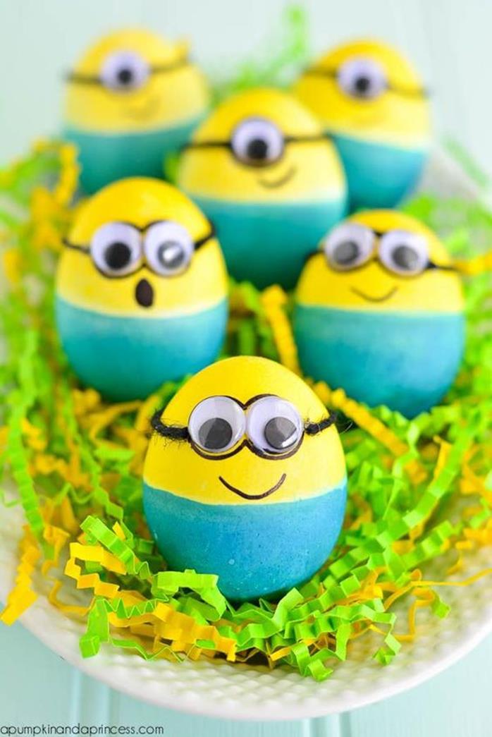 children's easter crafts idea, six eggs painted blue and yellow, and decorated with sticky eyes and marker, to look like minions
