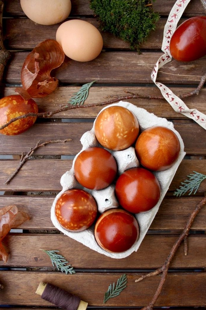 grey cardboard box, containing six naturally dyed eggs, half featuring leaf patterns, easter egg ideas, onion peels and branches, plain eggs and thread