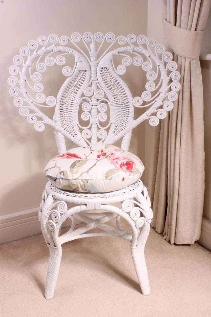 chair in white with ornamental, heart-shaped backrest, and floral cushion, shabby sheek look, beige carpet and curtains