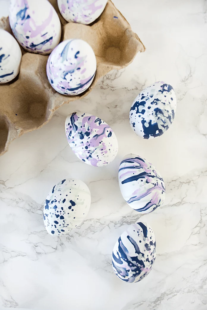 nine white eggs, decorated with runny blue and pink paint, using a straw, clever easter idea
