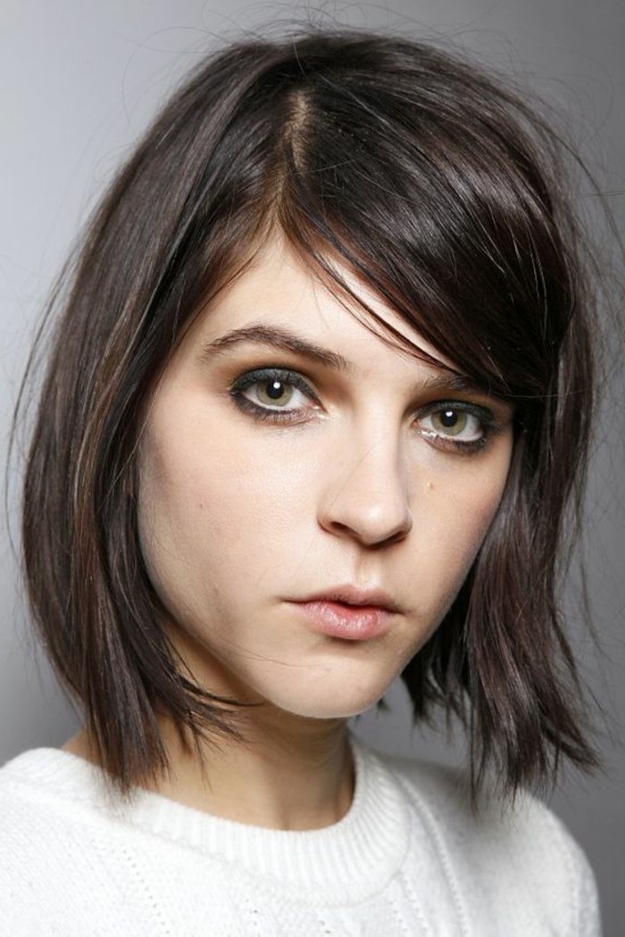 grey eyeliner and pale nude lipstick, worn by woman in white top, with hazel eyes, and fine side-parted-hair, brunette hairstyles