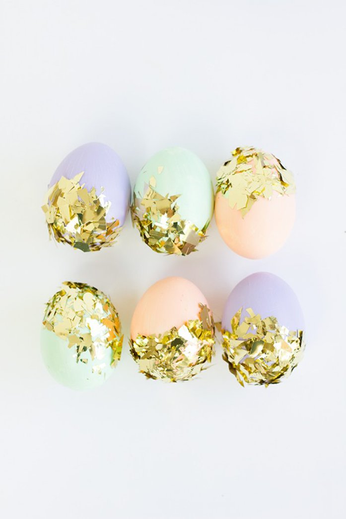 gold leaf used to partially decorate six eggs, dyed in pale pink, pale teal and pale violet, easter egg decorating, white background